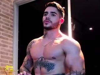 Hot muscled tanned gay hunk taking a shower